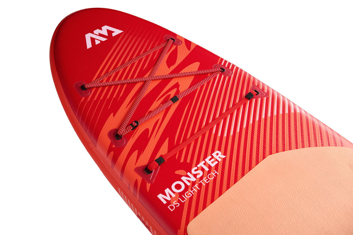 Nose of the 2026 Aqua Marina Monster showing the RED STRAP bungee cargo system and printed deck design