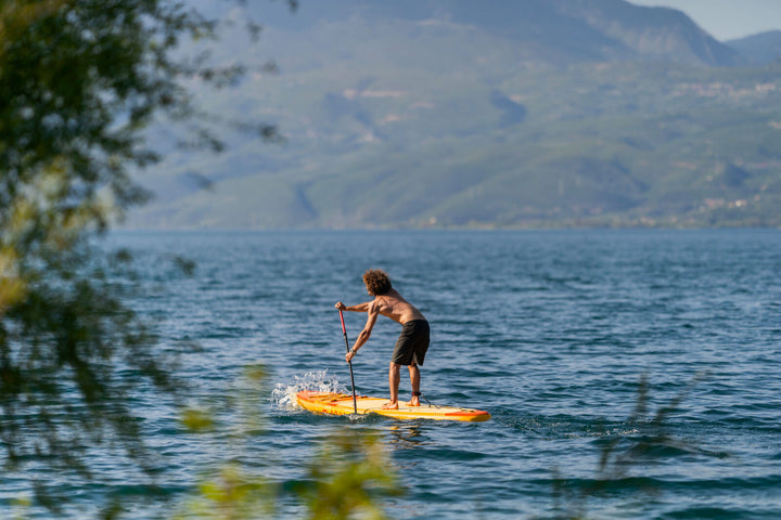 Paddler on the 2026 Aqua Marina Fusion 10'10" inflatable SUP on open water