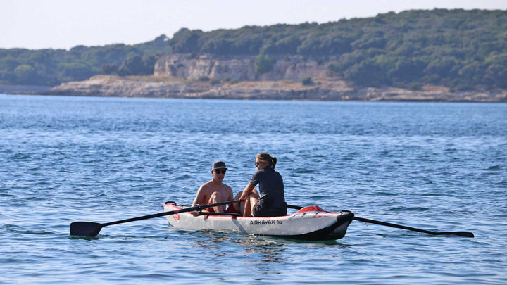 AIRKAYAK 16 inflatable kayak being paddled with two people aboard