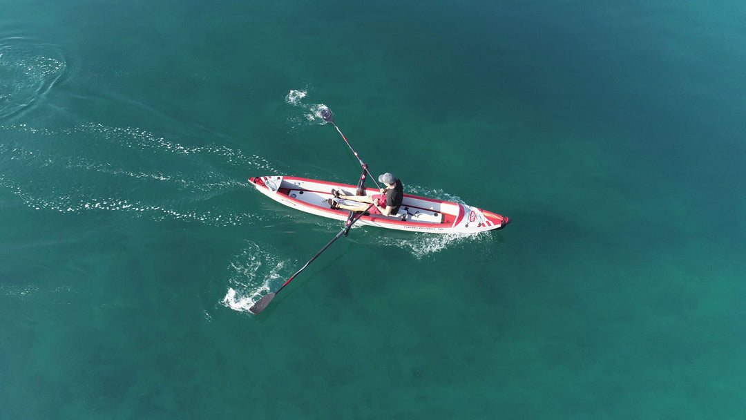 Rower sculling an AIRKAYAK 16 with the RowMotion deep outrigger rowing system