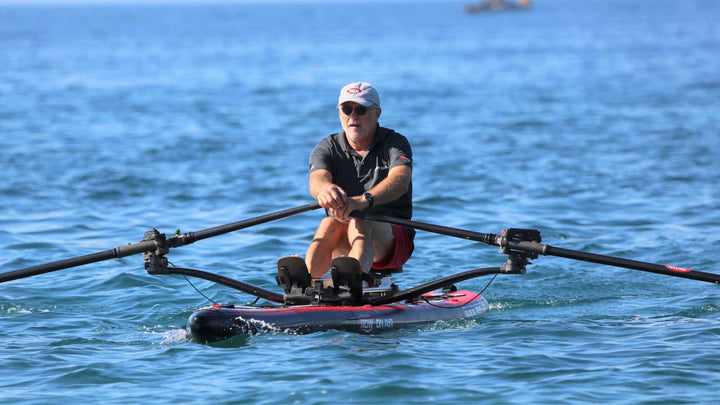DUDE 18 rowing board on the shoreline with its wheeled backpack