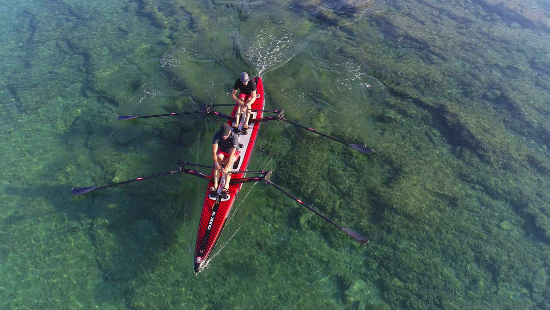 Two rowers double sculling a DUDE 18 fitted with RowVista forward rowing systems