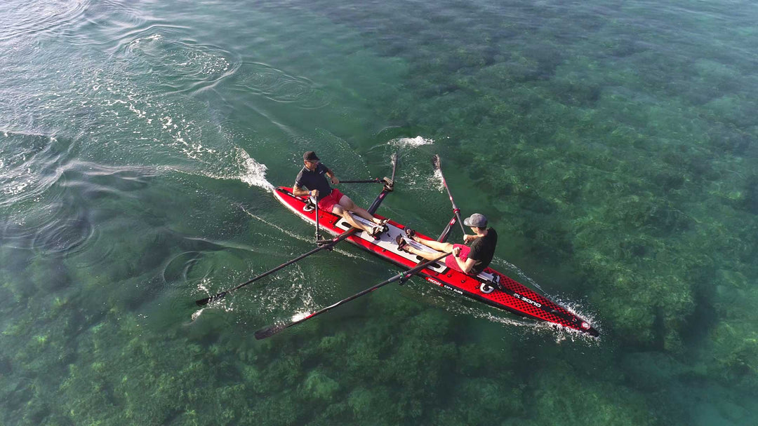 Aerial view of a ROWonAIR DUDE 18 inflatable rowing board being sculled on open water