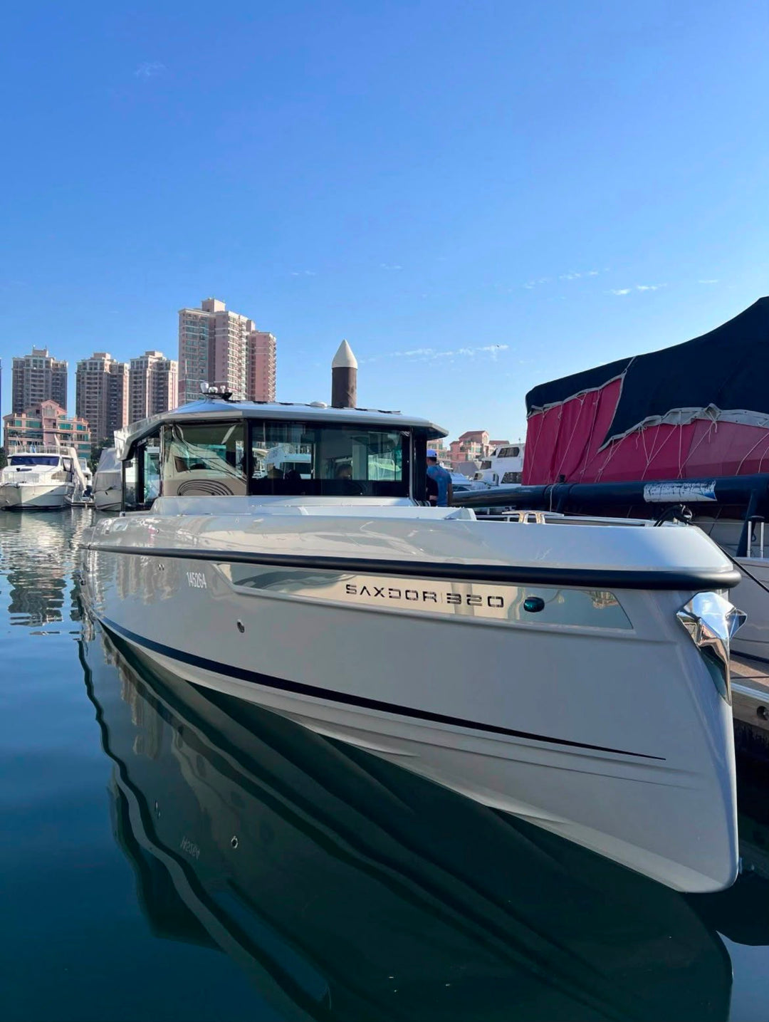 Saxdor 320 GTC bow view afloat, showing the Saxdor 320 hull graphic and Nordic reverse-bow styling