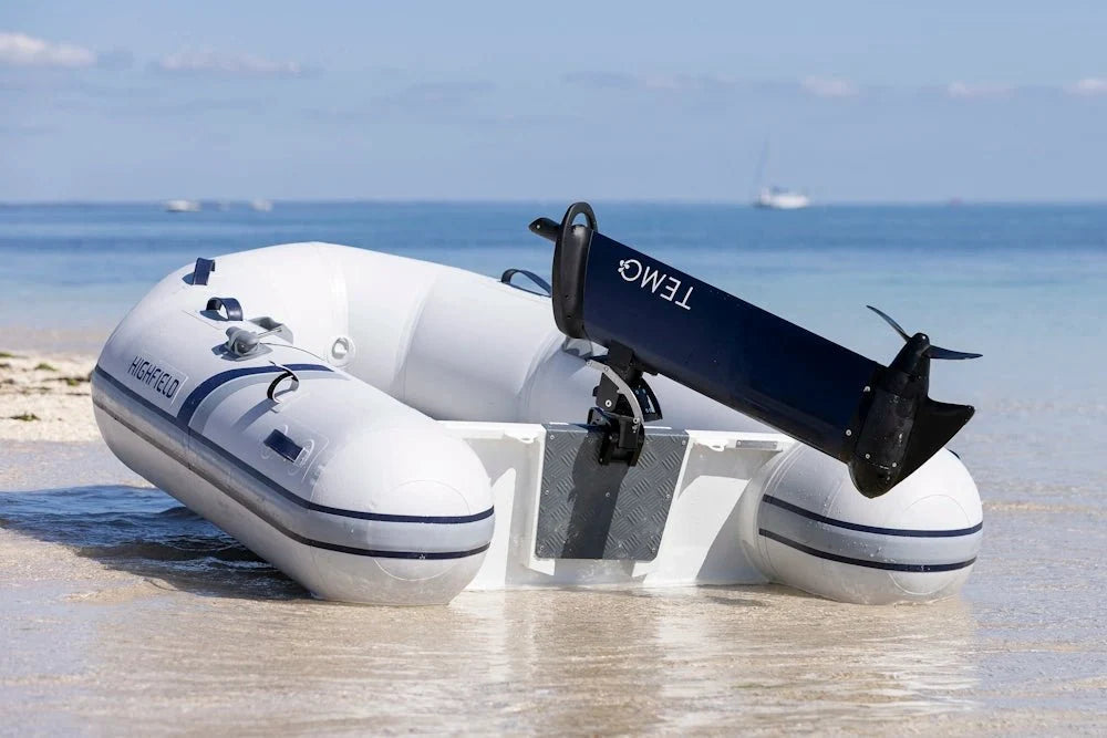 TEMO 1000 electric outboard motor mounted on an inflatable tender beached on sand