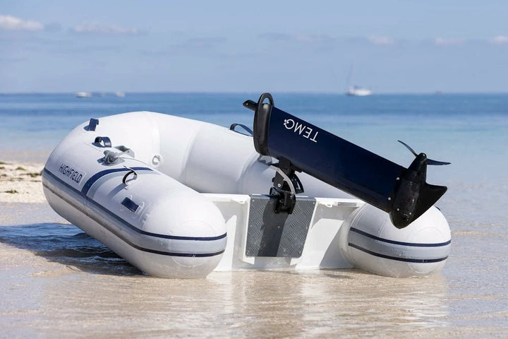 TEMO 1000 electric outboard motor mounted on an inflatable tender beached on sand