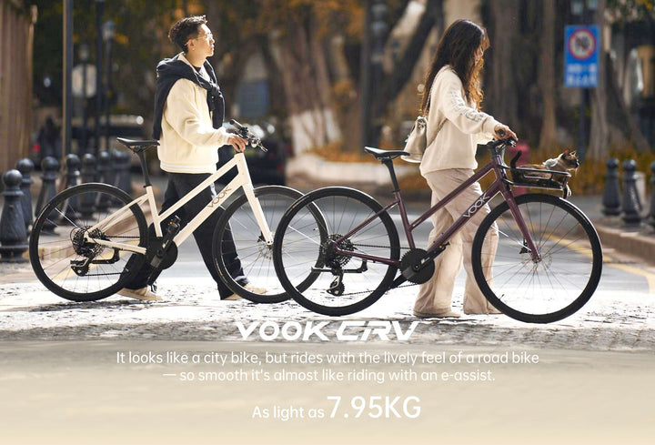 Two riders walking VOOK CRV bikes in white and claret on a city street