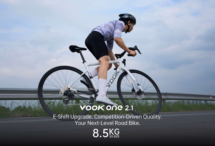 Cyclist riding the VOOK ONE 2.1 road bike on an open road, 8.5 kg XS